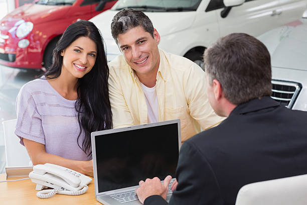 istock Smiling couple buying a new car 473455928