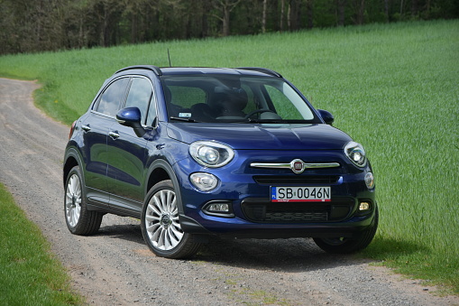 Kielce, Poland - May 8th, 2015: Fiat 500X stopped on the unmade road during the test drive. This vehicle is one of the most charming city crossovers on the European market.