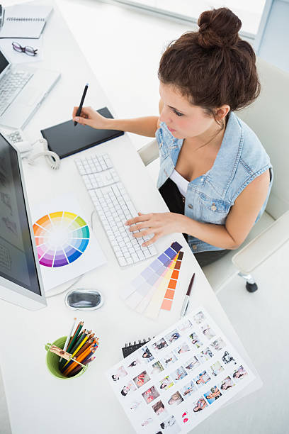 Designer working with colour wheel and digitizer Designer working with colour wheel and digitizer in the office graphic designer photos stock pictures, royalty-free photos & images