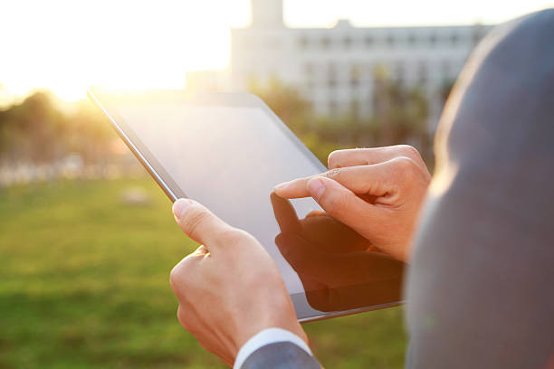 istock Businessman using his tablet outdoors 473458494