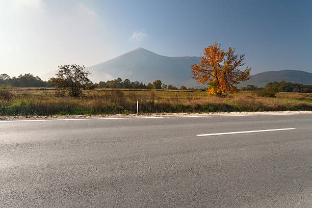 istock Side view of empty asphalt road in mountain area 473458638