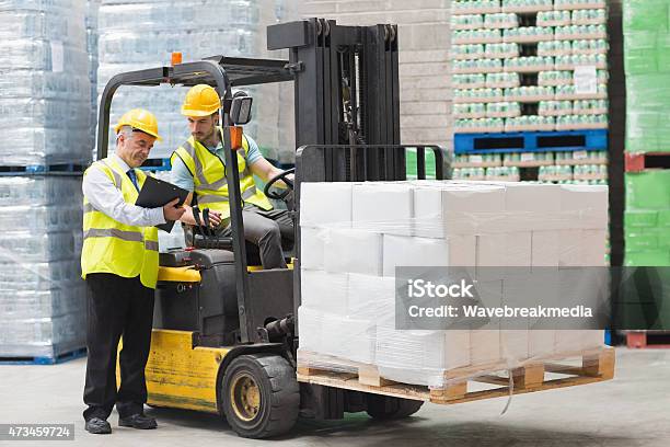 Forklift Driver Talking With His Manager Stock Photo - Download Image Now - 20-24 Years, 20-29 Years, 2015