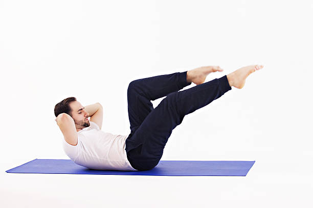 istock Man exercising on Mattress doing pilates 473462174