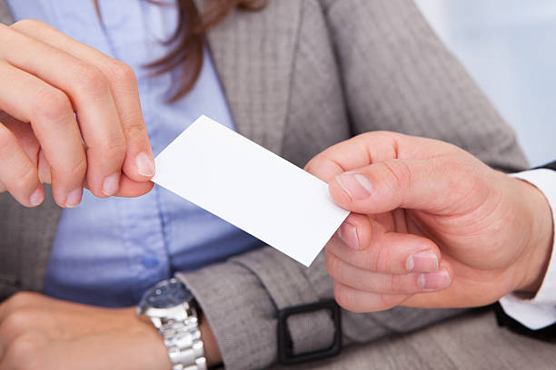 istock Businesspeople Holding Visiting Card 473463570