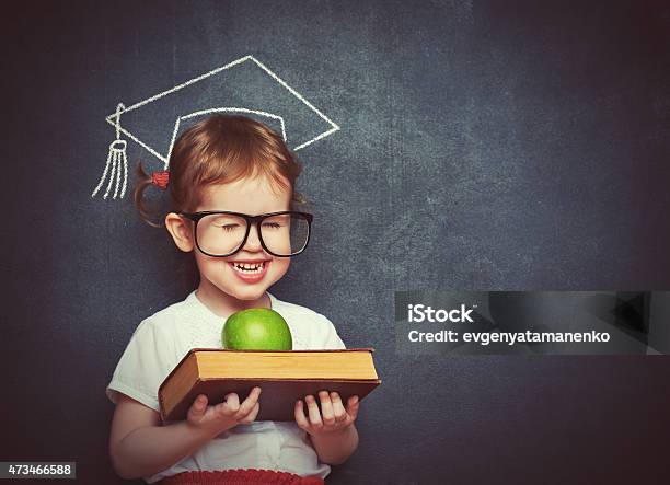 Girl Schoolgirl With Books And Apple In A School Board Stock Photo - Download Image Now