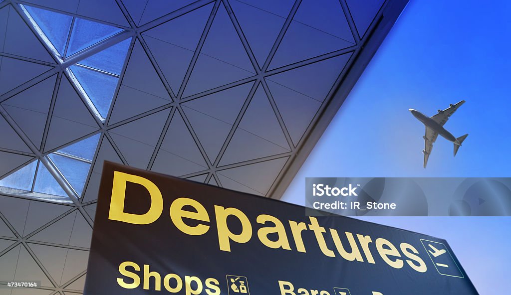 Departure sign in airport Departure sign in airport against of blue sky and plane in the sky Airport Stock Photo