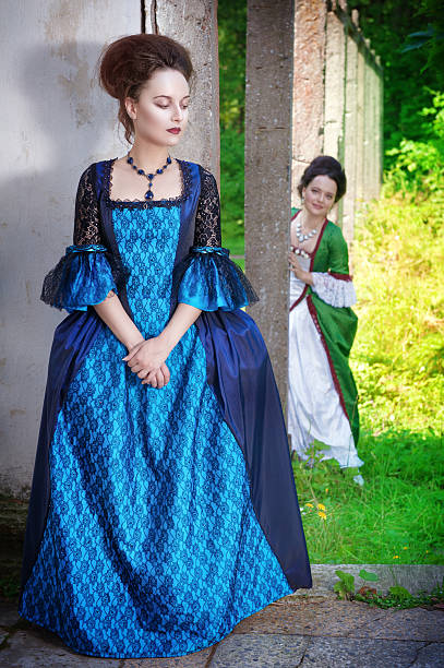 istock Two young beautiful women in long medieval dresses 473474200