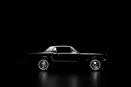 Izmir, Turkey - May 13, 2015: Izmir, Turkey - May 13, 2015.  Ford mustang 260 toy car product shot. Side view on a black background.