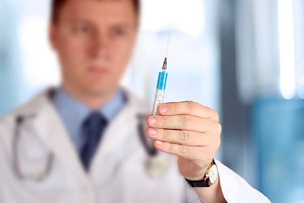 istock Young Doctor with syringe in his hand 473482878