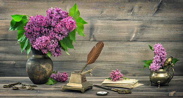 istock Still life with lilac flowers and antique writing tools 473487530