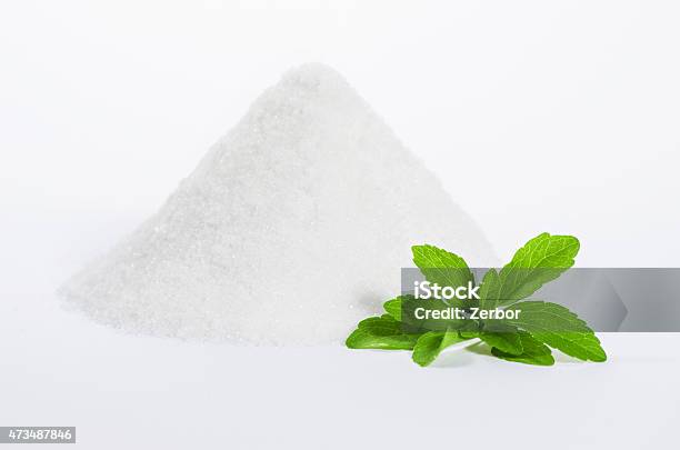 Stevia With A Pile Of Sugar Stock Photo - Download Image Now - Stevia, White Background, Sugar Substitute