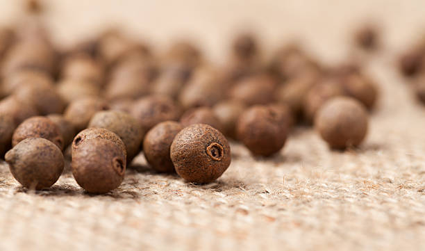 istock Raw allspice pepper aroma seeds close up texture on vintage 473491188