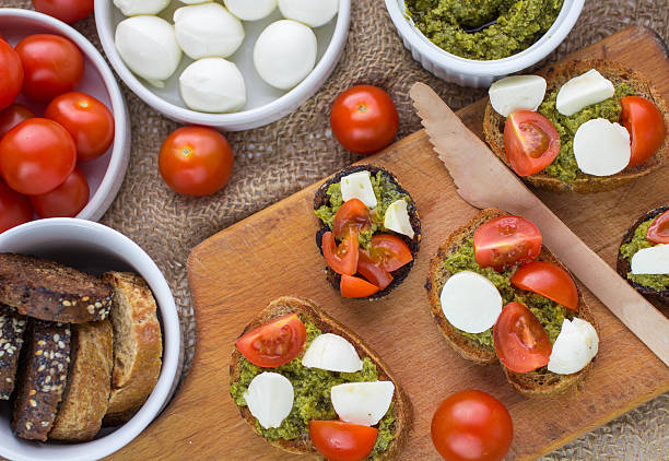 istock Bruschetta with fresh tomatoes, mozzarella and  herb pesto 473495850
