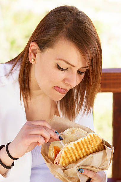 istock girl eating sandwich 473497876