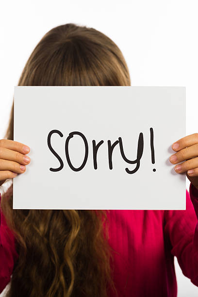 istock Child holding Sorry sign 473499272