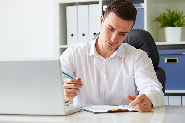 Young businessman signs a document