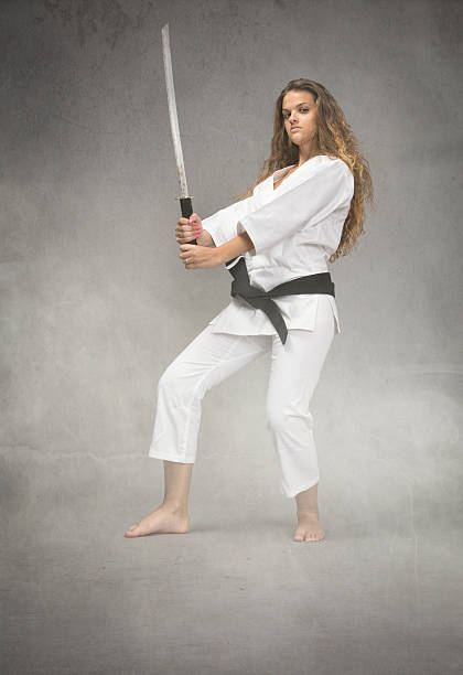 istock karate girl with sword on hand 473505740