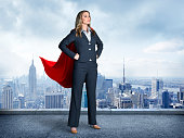 Superhero Businesswoman With Cityscape In The Background