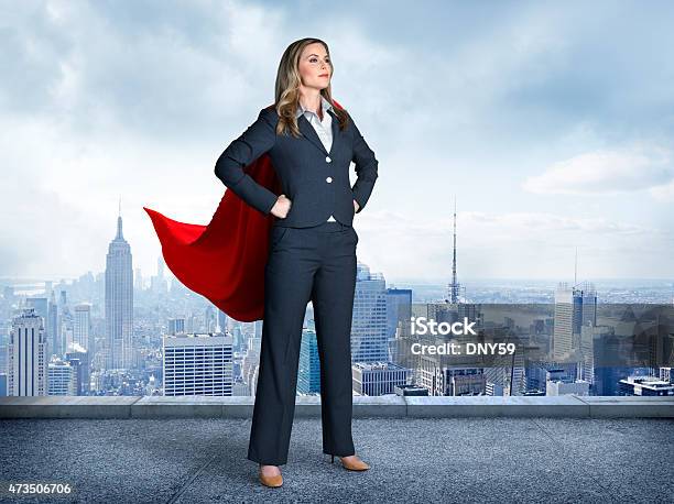 Superhero Businesswoman With Cityscape In The Background Stock Photo - Download Image Now