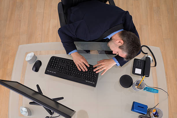 istock Businessman Sleeping On Desk 473507568