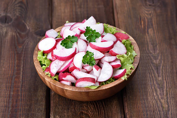 istock Radish salad on wooden table 473509096