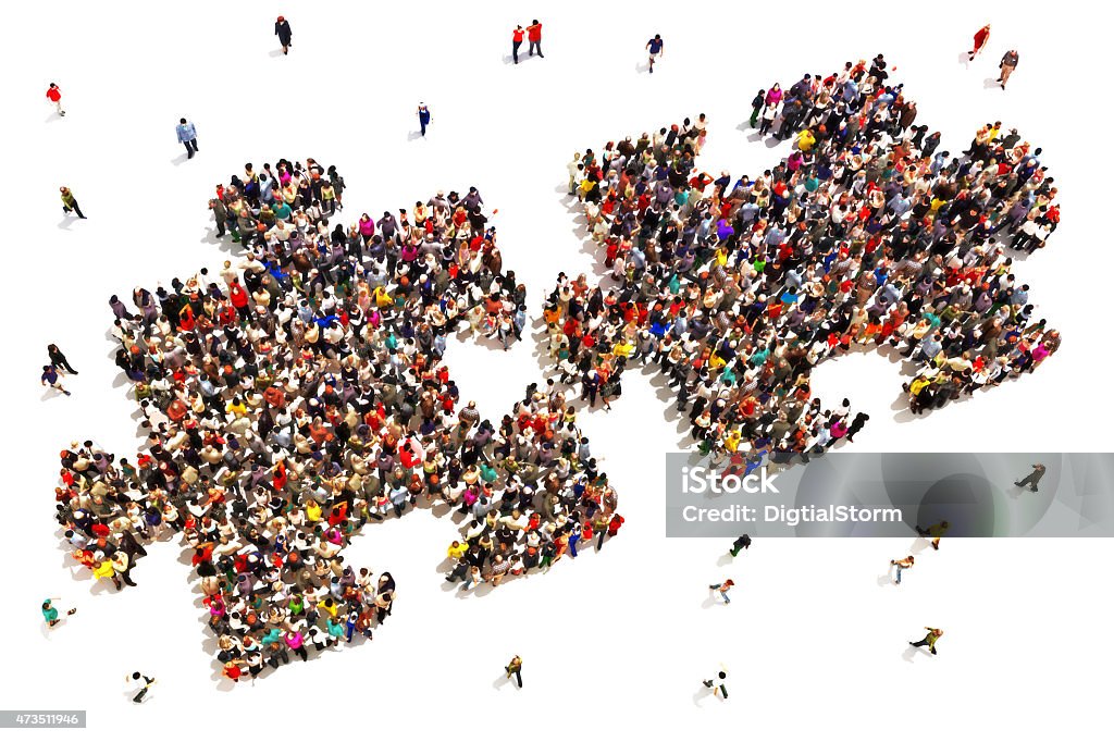 People putting the pieces together concept  Large group of people in the shape of two puzzle pieces on a white background. People Stock Photo