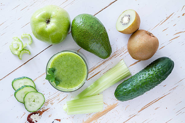 istock Green smoothie and ingredients - avocado, apple, cucumber, kiwi, lemon 473512432