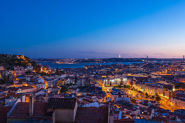 Aerial view of Lisbon rooftop from Senhora do Monte viewpoint (Miradouro)  by night in Portugal