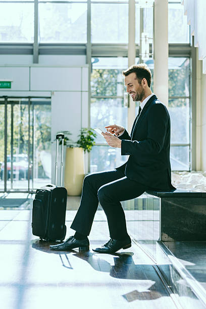 istock Businessman using a digital tablet in hotel hall 473519526
