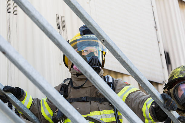 istock Female firefighter in protective gear and oxygen mask 473519618