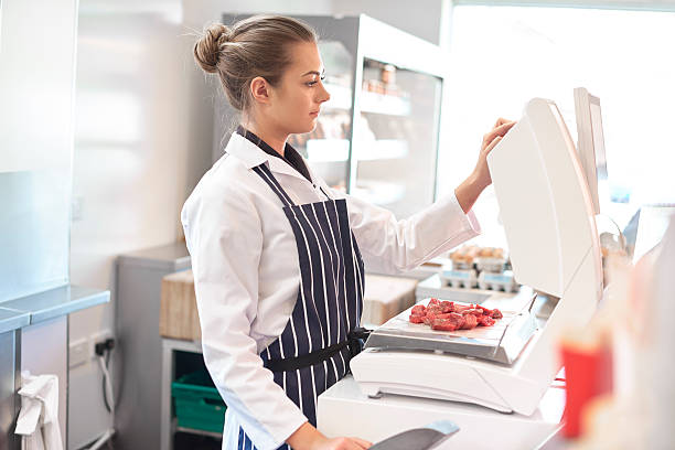 istock young female butcher portrait 473521992