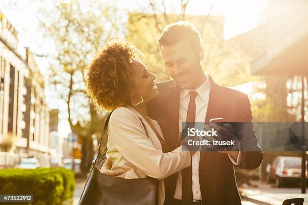 Elegant Couple Flirting Outdoor Man Holding Smart Phone Stock Photo - Download Image Now