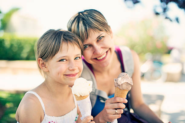 istock Mother and daughter eating ice cream 473525570