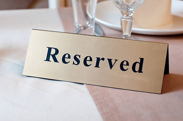 Reserved sign, reservation. On the table. Beige