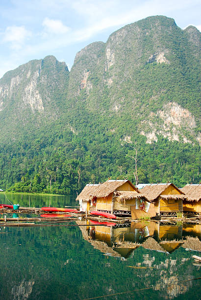 istock Tropical lakeside hut and wooden boat 473529088