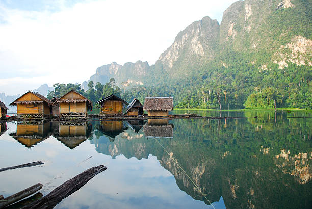 istock Tropical lakeside hut and wooden boat 473529100