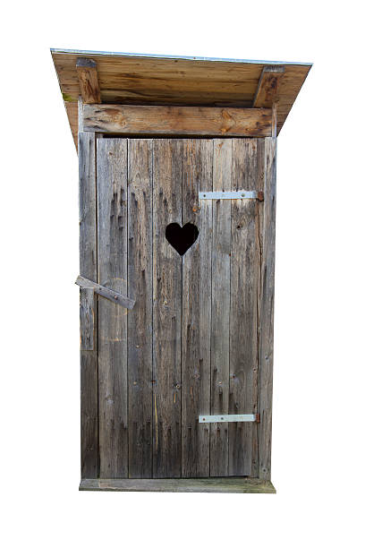 Old wooden door to outhouse with heart shaped opening Small wooden outdoors toilet isolated on white Outhouse stock pictures, royalty-free photos & images