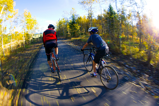 A father and son ride road bicycles on the Legacy Trail in Alberta, Canada.