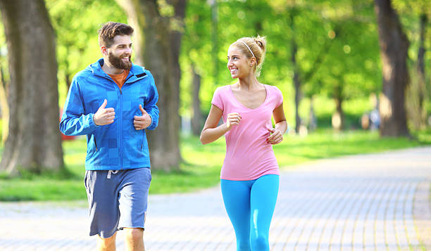 istock Young couple jogging in local park. 473534900