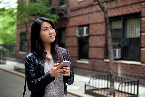 A young woman with smart phone in New York city.