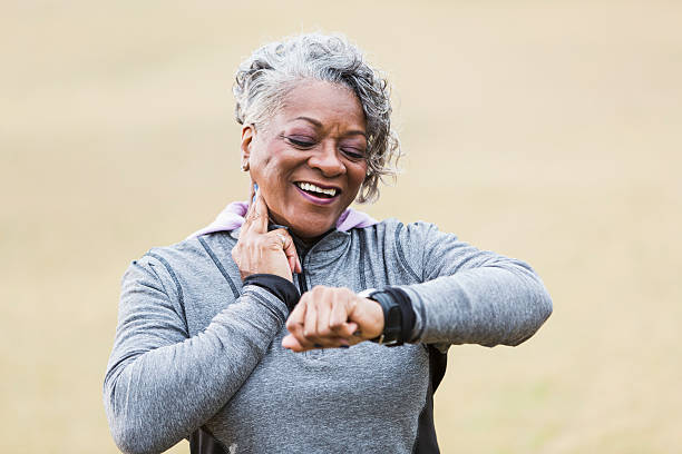 istock Senior woman exercising, taking pulse 473546548