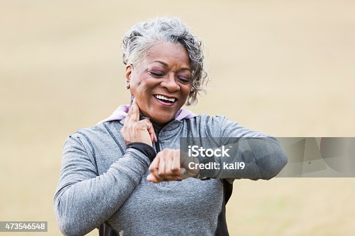 istock Senior woman exercising, taking pulse 473546548