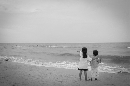 boy and girl seaside black and white images old style.