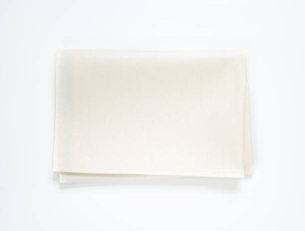 istock Folded ivory-white linen napkin on plain white background 473550900