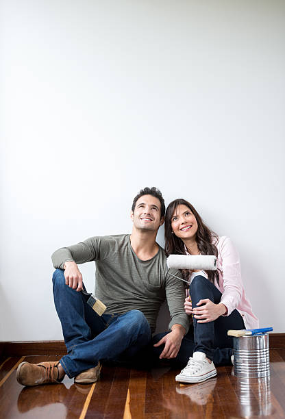 istock Thoughtful couple painting their house 473551486