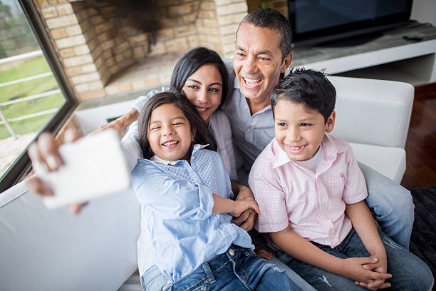 istock Latin American family taking a selfie 473559022