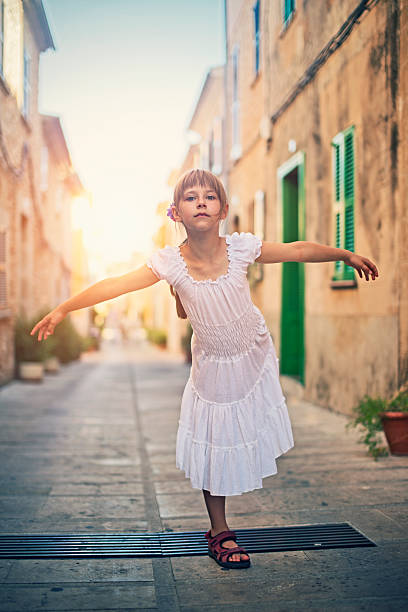 istock Little girl standing on one leg 473559174