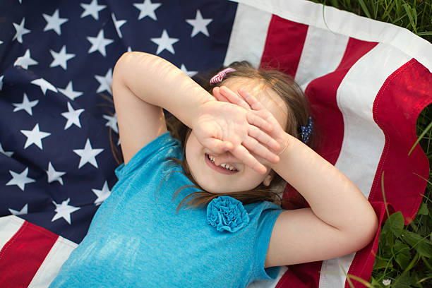 istock Cute girl outdoors in a meadow on july 4th. 473559296