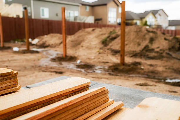 istock New fence construction. Fence posts in background, timber in foreground. 473559576