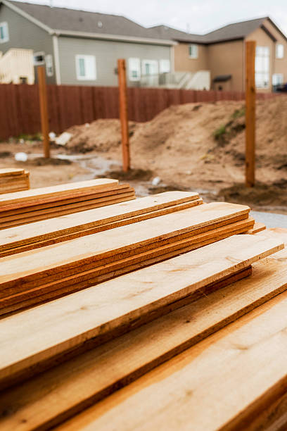 istock New fence construction. Fence posts in background, timber in foreground. 473559590
